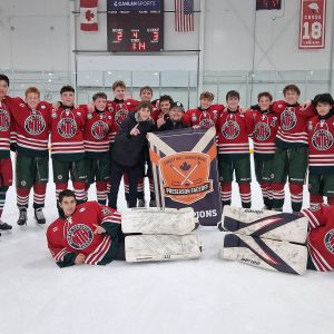 NT U17 A Green team celebrates on the ice with the Canlan Preseason Faceoff championship banner